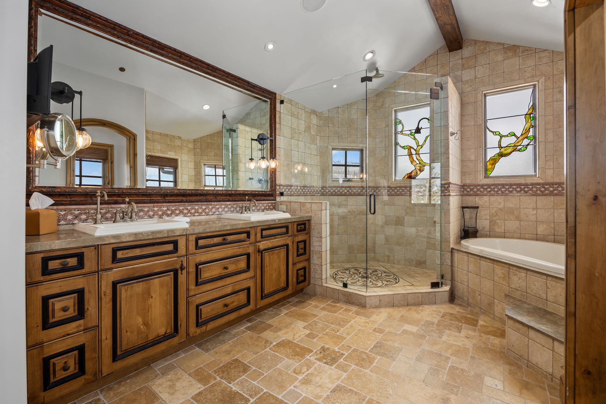 grand primary en suite bath with soaking tub and large glass shower